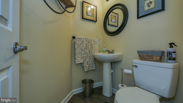 bathroom with sink, wood-type flooring, and toilet