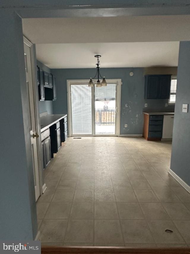 kitchen with a wealth of natural light and an inviting chandelier