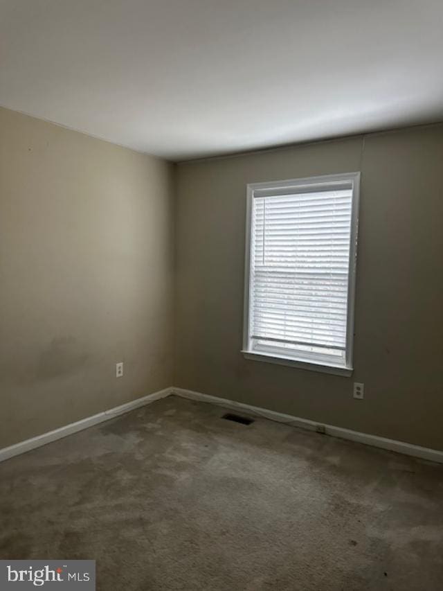 empty room featuring dark carpet