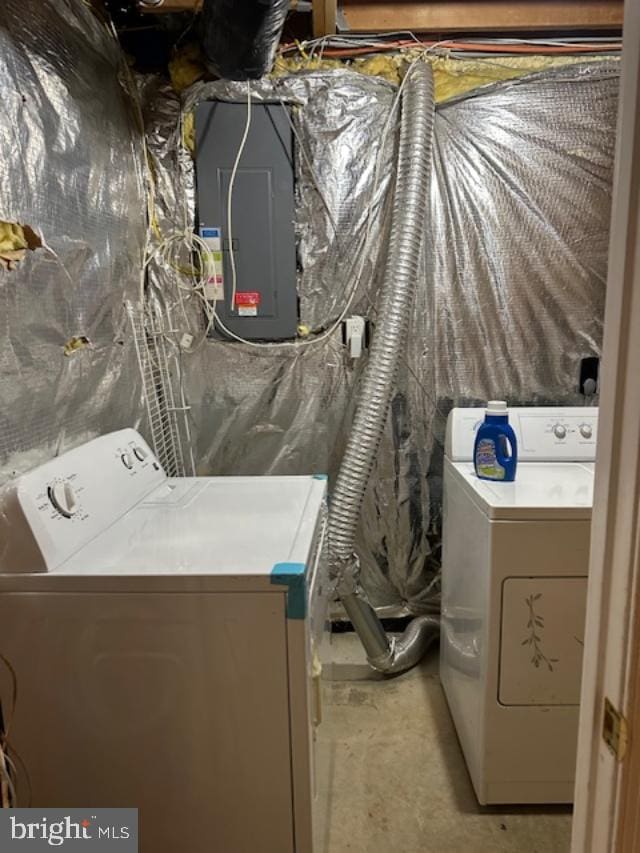 clothes washing area with washer and dryer and electric panel