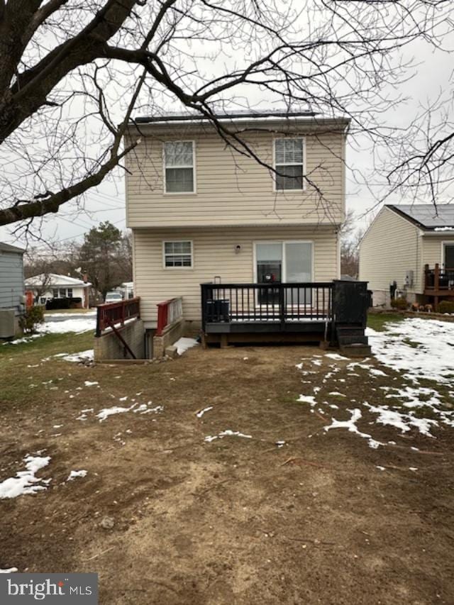 snow covered property featuring a deck