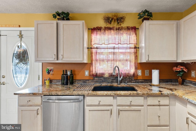 kitchen with dishwasher, light stone countertops, sink, and a wealth of natural light