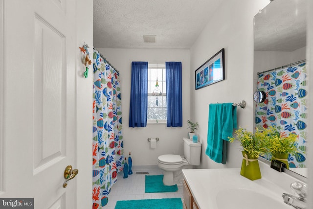 bathroom with tile patterned flooring, a textured ceiling, toilet, vanity, and a shower with shower curtain