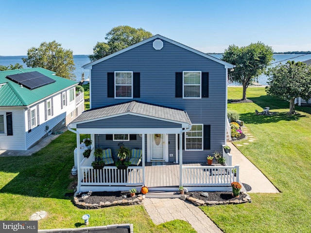 view of front of home with a water view, a porch, and a front yard