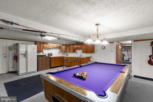 game room with a textured ceiling and billiards