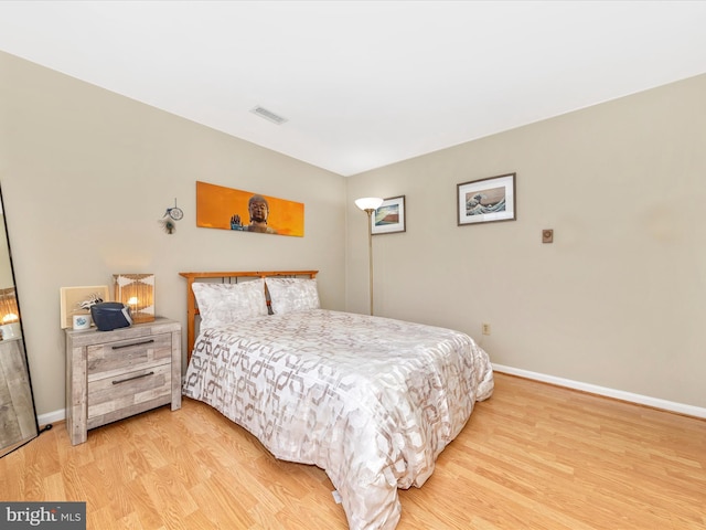 bedroom with hardwood / wood-style floors