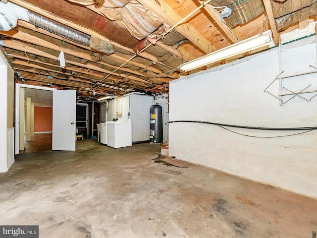 basement featuring washing machine and dryer and water heater