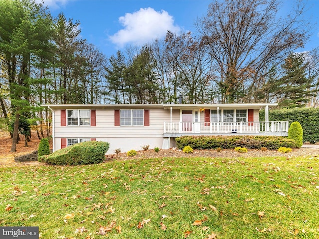 view of front of property featuring a front lawn and a wooden deck