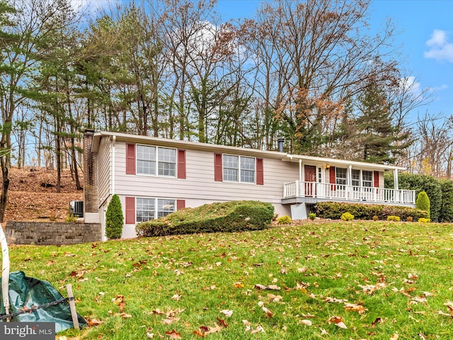 view of front of property featuring central AC and a front lawn