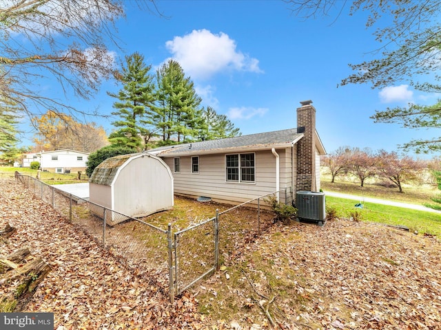 view of side of property with a storage unit and central air condition unit