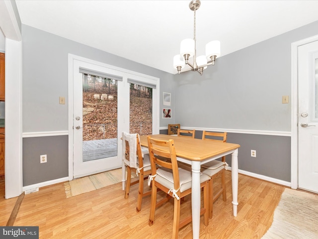 dining room with an inviting chandelier and light wood-type flooring