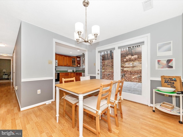 dining room featuring a chandelier and light hardwood / wood-style floors