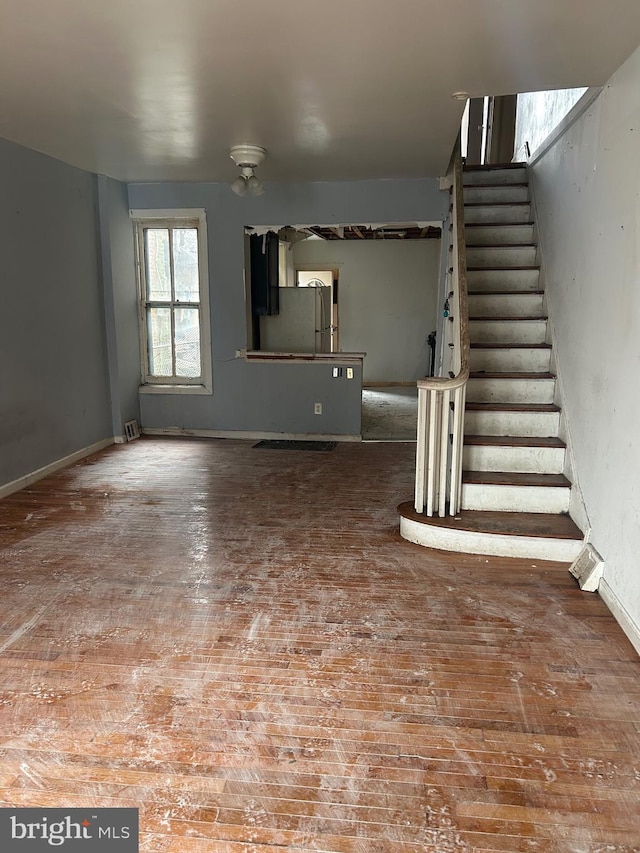 1907 Page St, Philadelphia, PA 19121 - unfurnished living room with stairs, ceiling fan, and baseboards