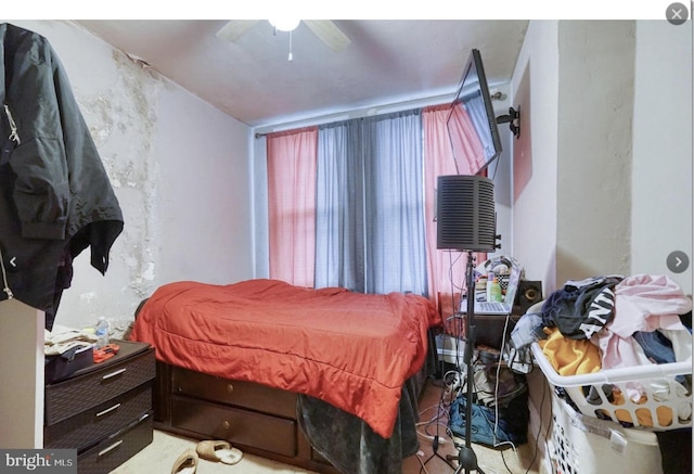 bedroom featuring an AC wall unit and ceiling fan