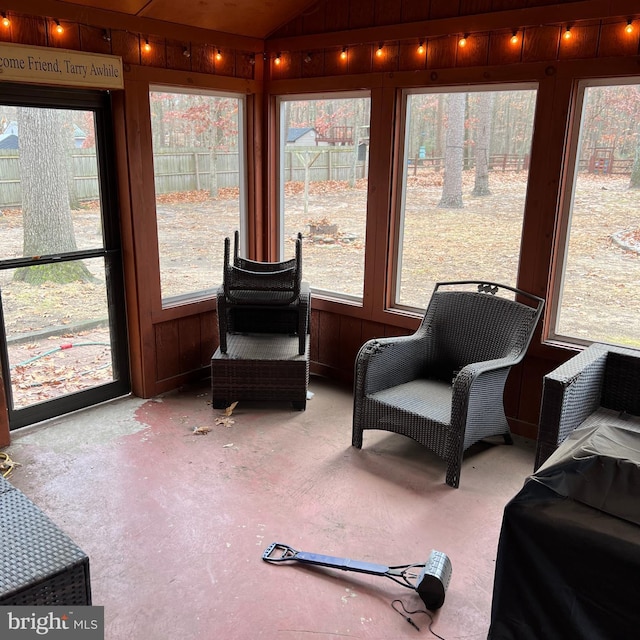 sunroom with a healthy amount of sunlight and lofted ceiling