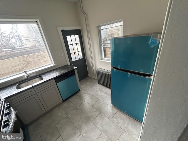 kitchen with dishwasher, radiator heating unit, sink, refrigerator, and light tile patterned floors