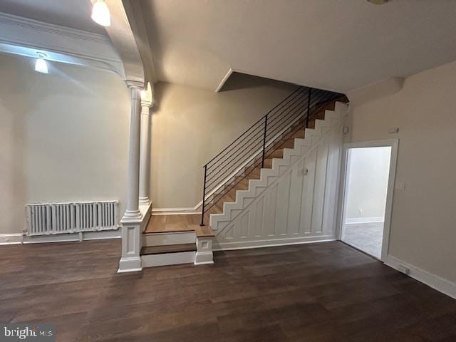 stairs featuring hardwood / wood-style flooring and ornate columns