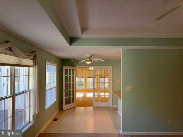 empty room featuring french doors and ceiling fan