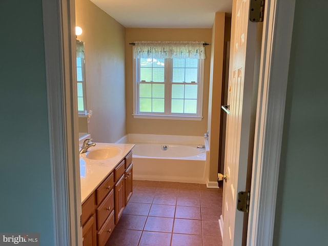 bathroom featuring tile patterned floors, vanity, and a bathing tub