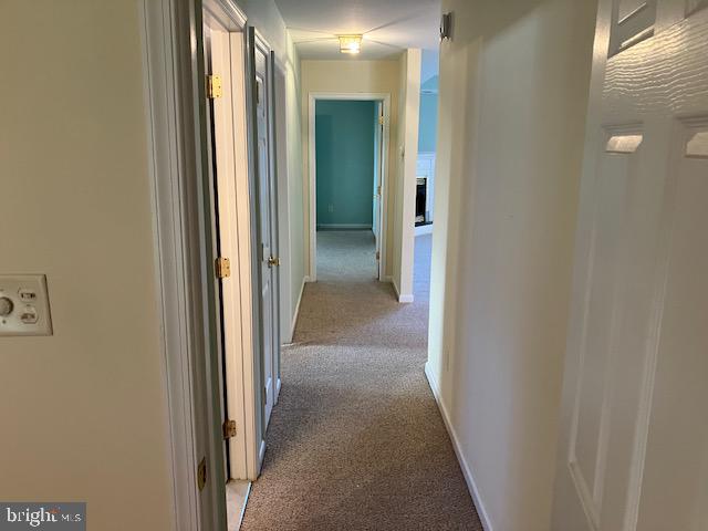 hallway featuring light colored carpet