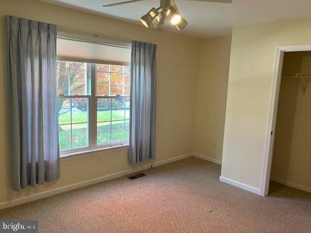 unfurnished bedroom with a closet, ceiling fan, and light colored carpet