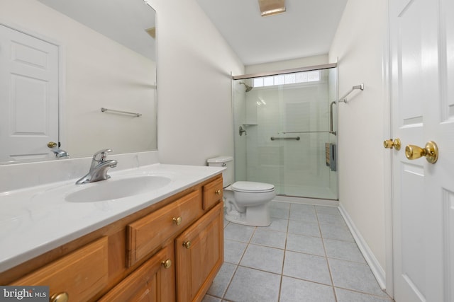 bathroom featuring toilet, vanity, tile patterned floors, and an enclosed shower