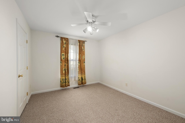 spare room featuring ceiling fan and carpet