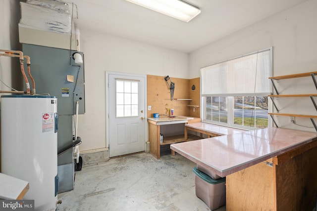 kitchen with electric water heater and kitchen peninsula