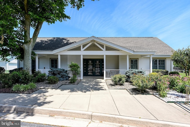 view of front of property featuring covered porch and french doors