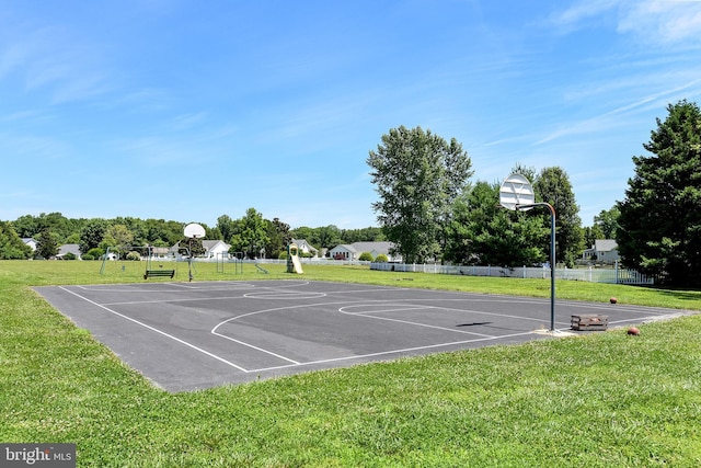 view of sport court with a yard