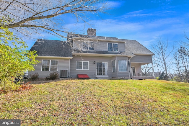 rear view of property with a yard