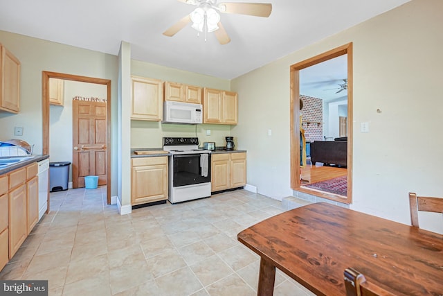 kitchen featuring light brown cabinets, light tile patterned floors, and white appliances