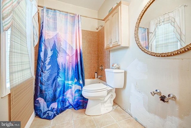 bathroom featuring tile patterned flooring, toilet, and shower / tub combo with curtain