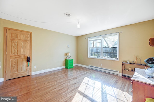 interior space featuring a baseboard radiator and light hardwood / wood-style floors