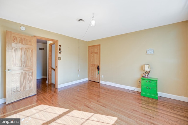 unfurnished room with hardwood / wood-style floors