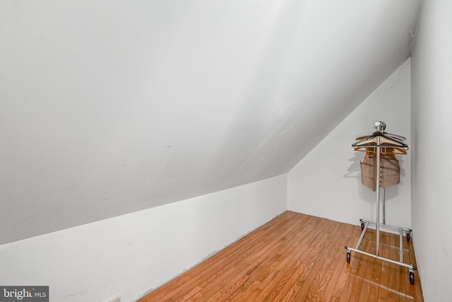 additional living space featuring hardwood / wood-style flooring and lofted ceiling