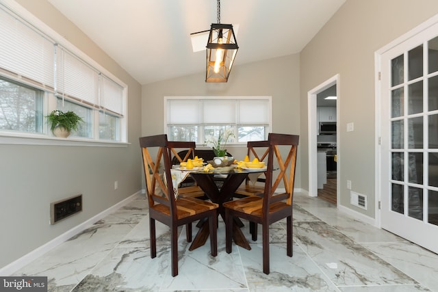 dining area with lofted ceiling