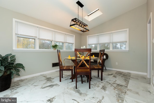 dining space with plenty of natural light and vaulted ceiling