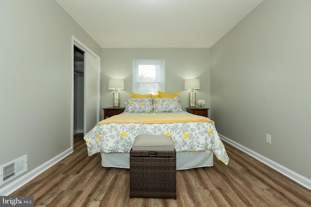 bedroom with a closet and dark hardwood / wood-style floors