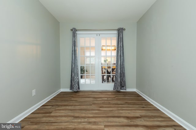 unfurnished room featuring french doors and wood-type flooring