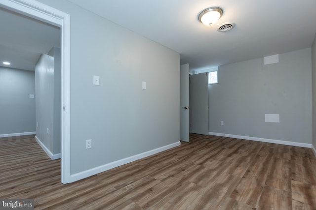 unfurnished room with wood-type flooring