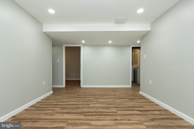 basement with light hardwood / wood-style flooring