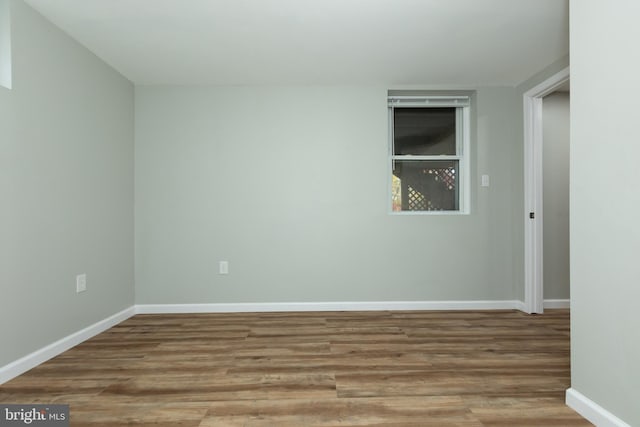 unfurnished room with wood-type flooring