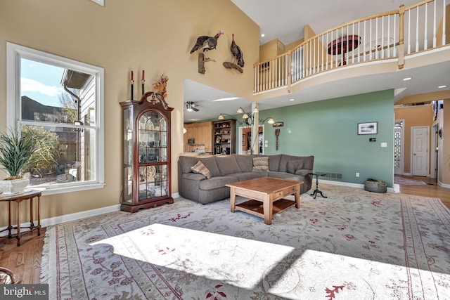 living room with a high ceiling and light hardwood / wood-style flooring