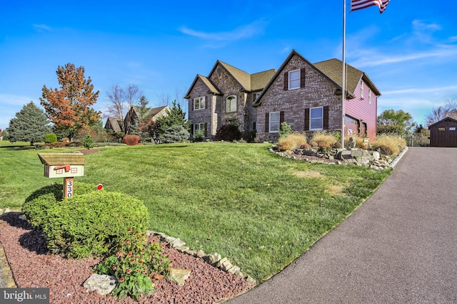 view of front of home featuring a front lawn and a garage