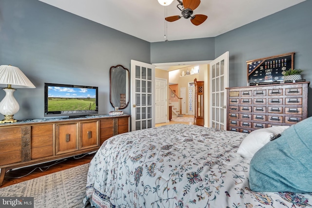 bedroom featuring ceiling fan, ensuite bathroom, and dark wood-type flooring