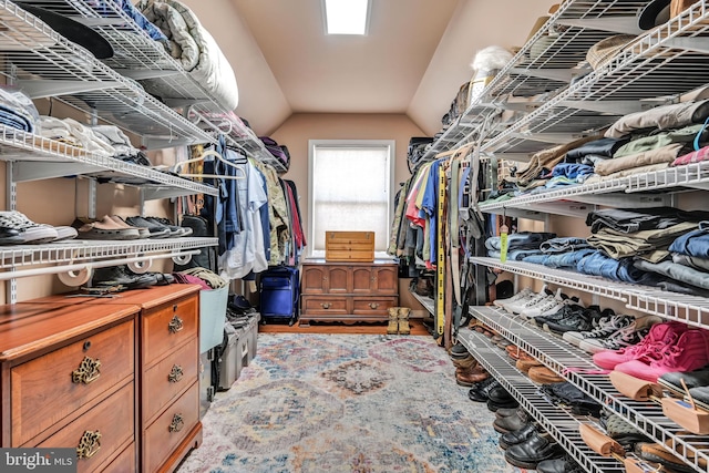 walk in closet featuring lofted ceiling