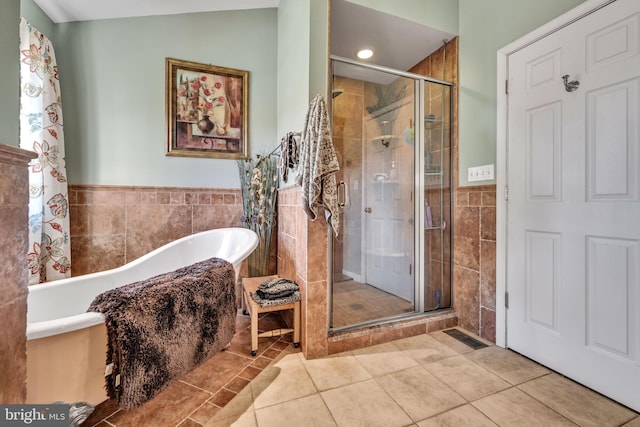 bathroom featuring tile patterned floors, tile walls, independent shower and bath, and vaulted ceiling