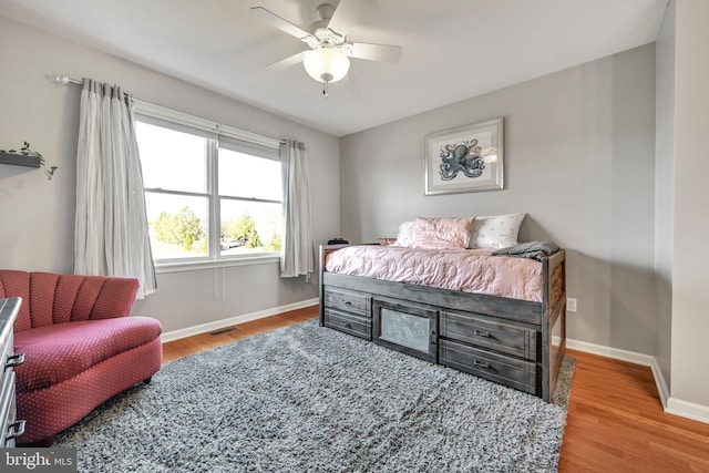 bedroom with hardwood / wood-style flooring and ceiling fan