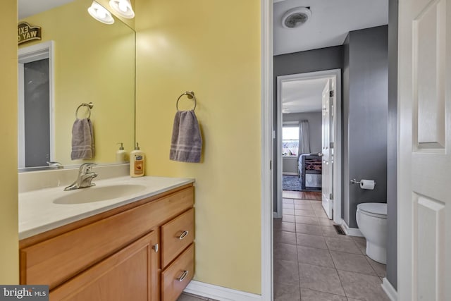 bathroom with tile patterned flooring, vanity, and toilet